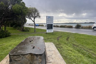 Tire marks in grass around stolen statue remains